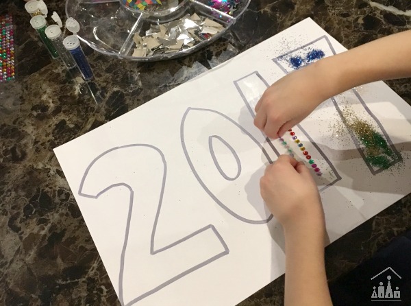 Child making a New Years Eve Year collage